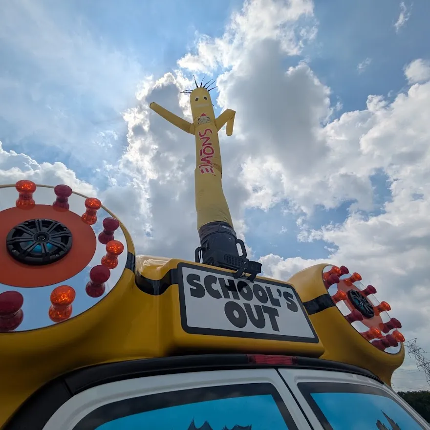 Bob the inflatable mascot rising between the bus's two roof speakers