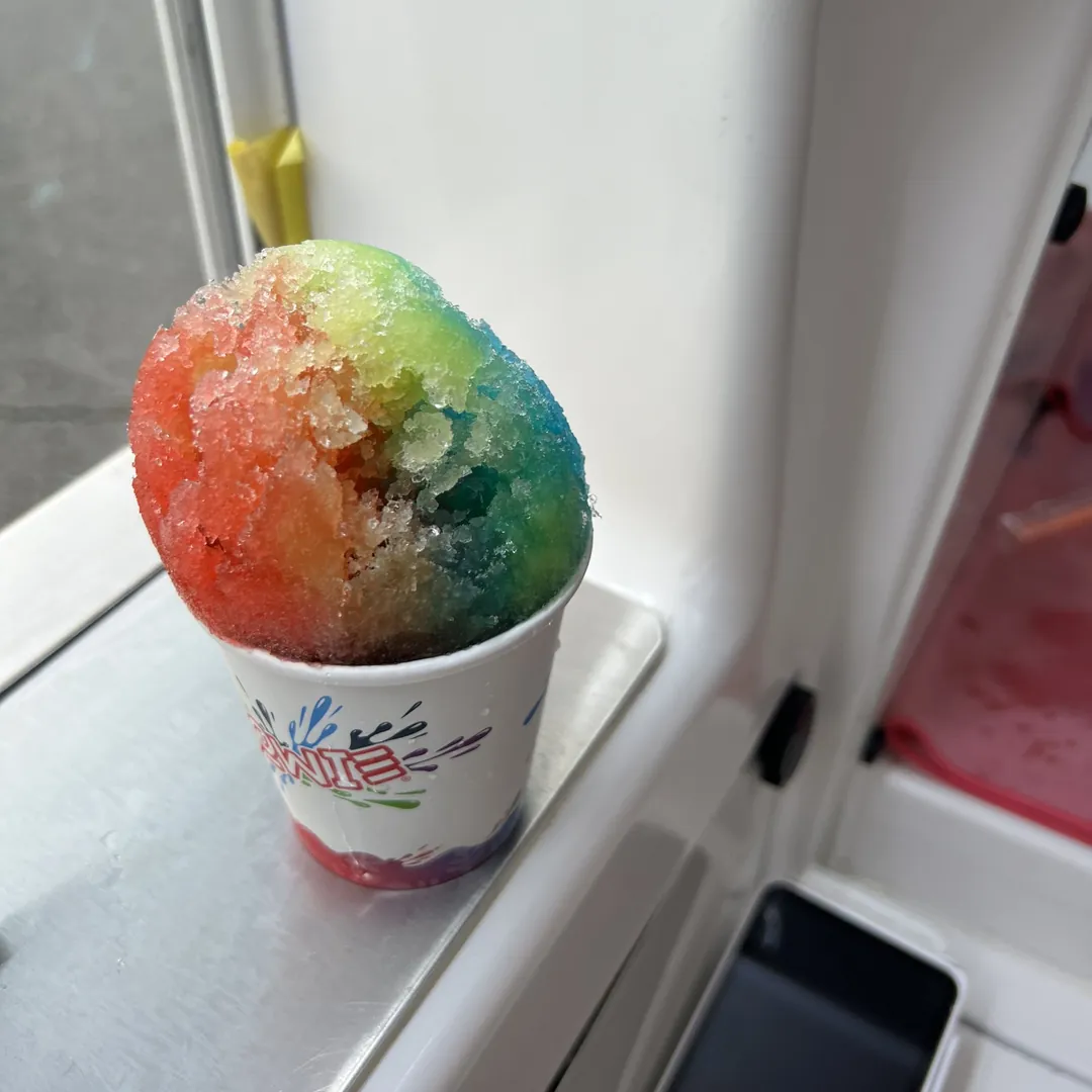 A rainbow Snowie Shaved Ice on the serving window ledge